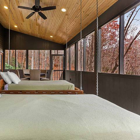 The screened in porch has two swinging beds.