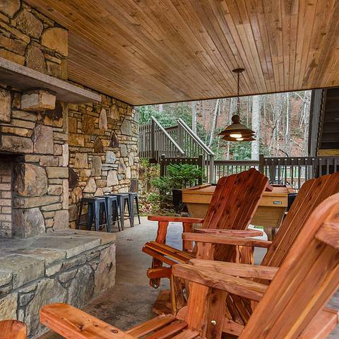 Outdoor fireplace on covered porch.