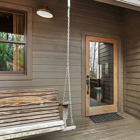 Wooden swing on front porch.