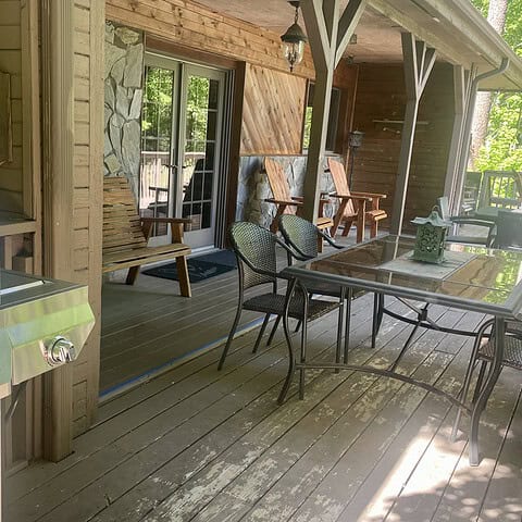 Our House porch features a propane grill, two tables, two Adirondack chairs, and five additional chairs - The Cove at Fairview - Vacation Rentals - Asheville, NC